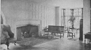 This is in reality a moderate-sized room, yet the open
arrangement and the clear center give the impression of great space. The
curve of the fireplace and the oak panelling are simple Tudor. The
furniture is a mixture of many kinds.