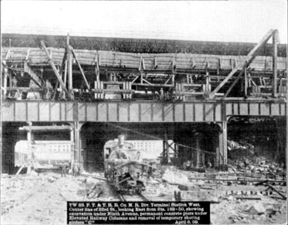 Plate XLIX, Fig. 3.&mdash; TW 88, P.T. & T.R.R. Co. N.R. Div. Terminal Station West. Center line of 32nd St., looking East from Sta. 183+50, showing excavation under Ninth Avenue, permanent concrete piers under Elevated Railway Columns and removal of temporary shoring girders "C". April 8, 09.
