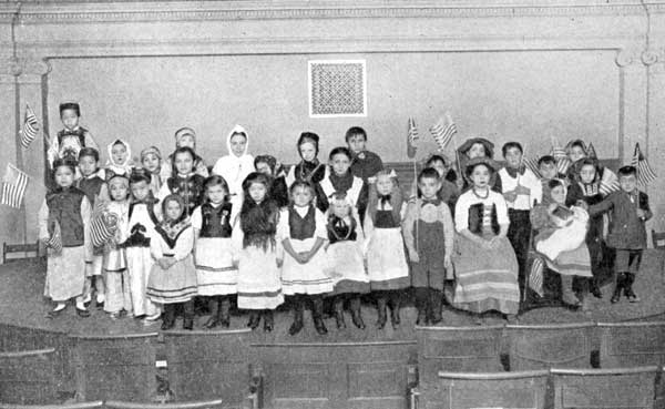 Children of Many Nationalities at Christmas
Celebration in a New York School.

Chinese, Italians, Swedes, Irish, English, German, French, Russian,
Austrian.