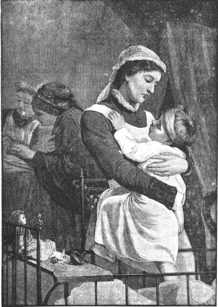 Nurse holding baby with another in back ground
