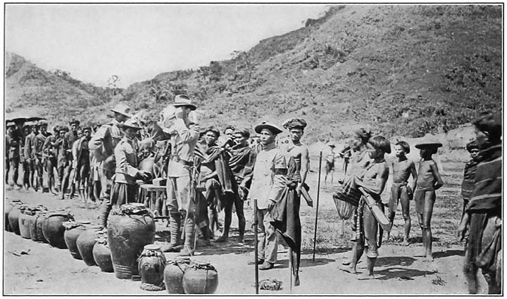Fig. 1. Scene at a Ki&aacute;n͠gan celebration. Note the Chinese jars in the foreground. Those that Ban͠gg&iacute;l&icirc;t brought from the village of souls, in the Sky World, are of the type of the third jar from the left. (Photograph by Tomlinson.)
