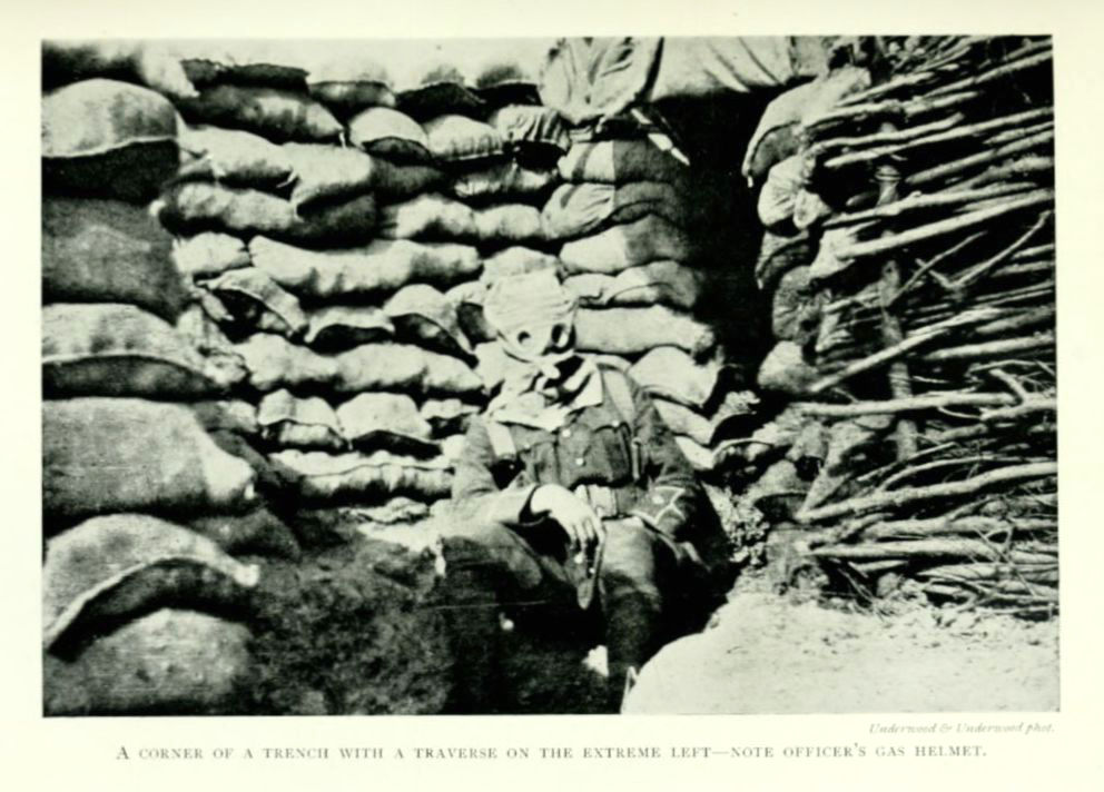 A corner of a trench with a traverse in the extreme left&mdash;note
officer’s gas helmet.